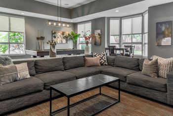 a living room with couches and a coffee table at The Pointe at St. Joseph Apartments, South Bend, IN